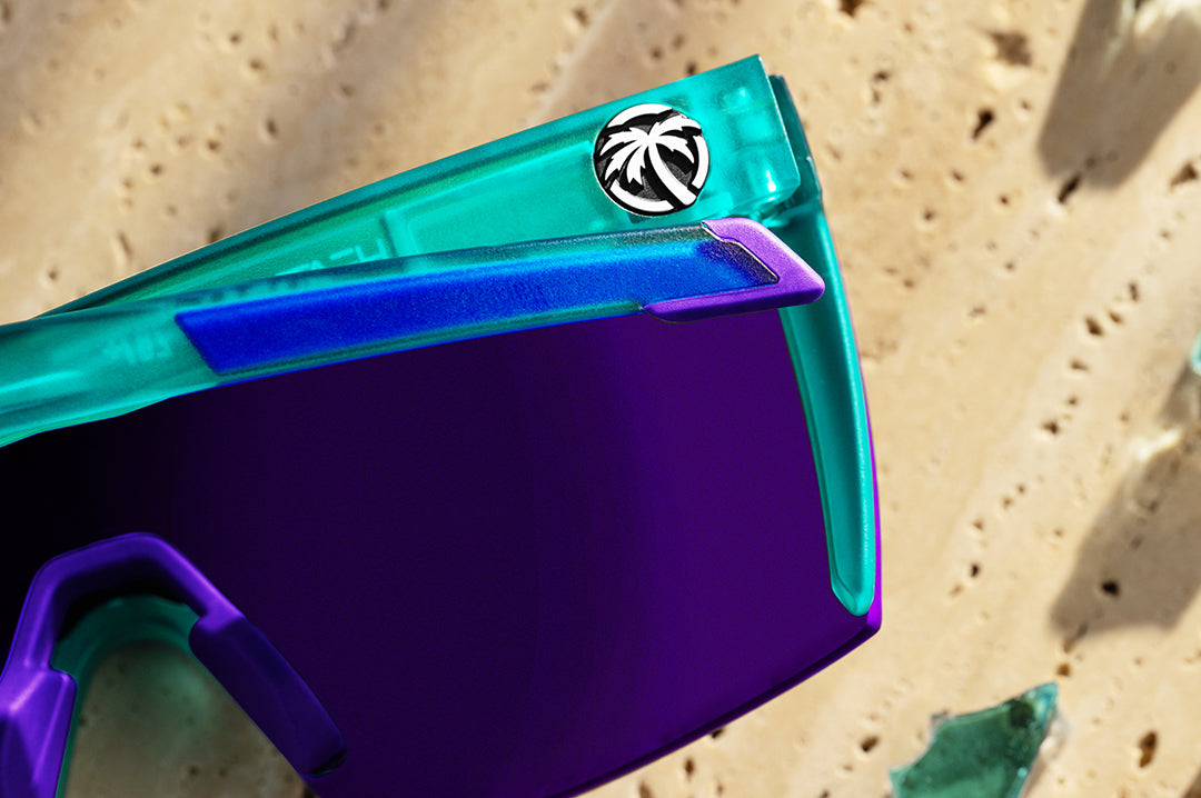 Close up of arm of Heat Wave Performance Lazer sunglasses with purple lenses and aqua frame