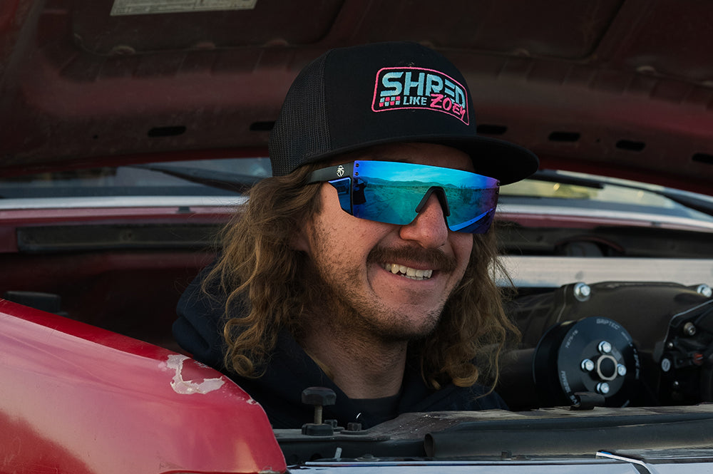 Black Wilkey wearing Heat Wave Lazer Slim sunglasses with galaxy blue lens.