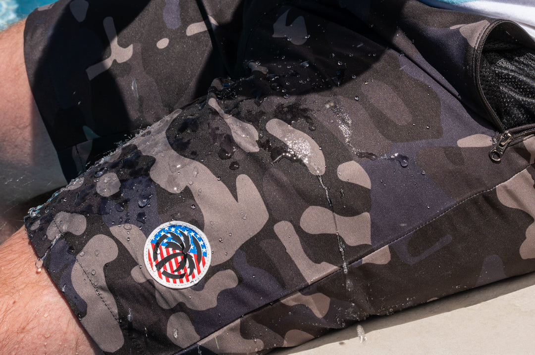 Close up of water on the Heat Wave Visual Midnight Camo Board Shorts.