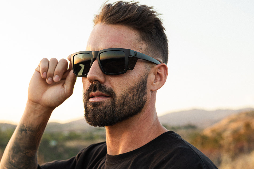 Young dude in the desert rocking the Heat Wave Visual Performance XL Vise Ultra Black Sunglasses.