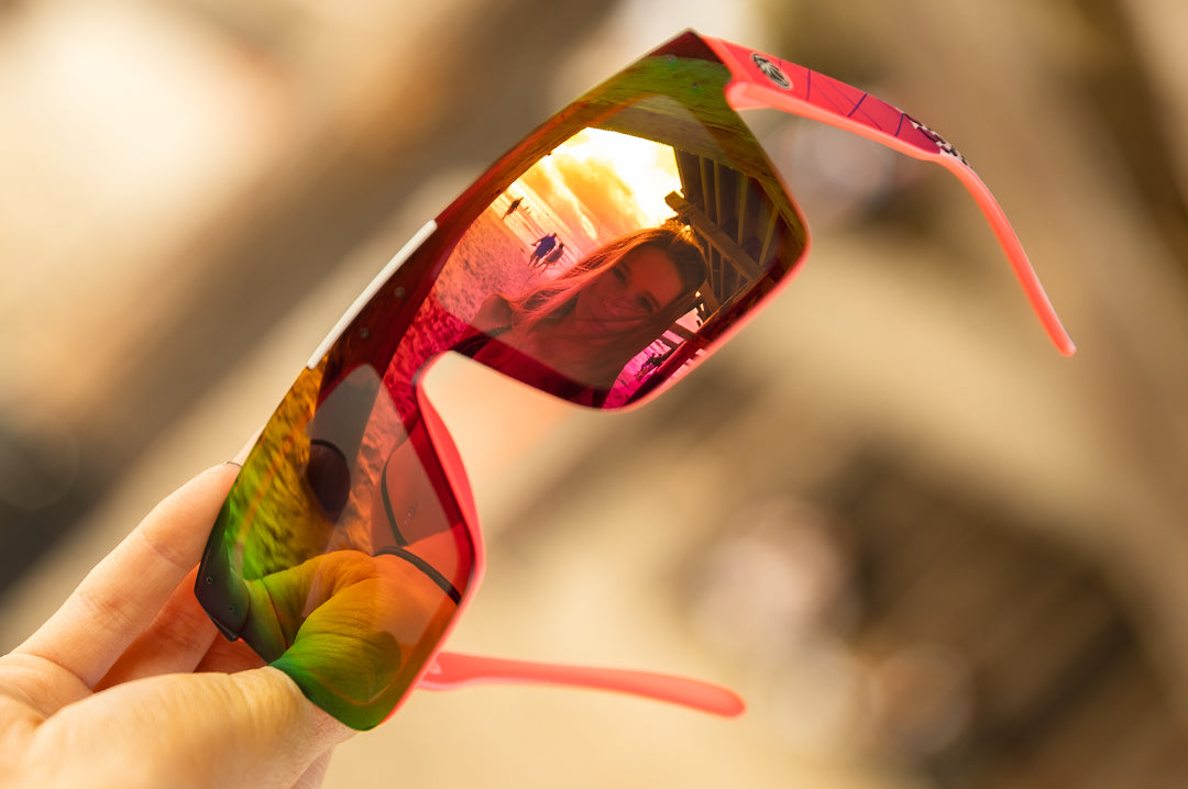 Reflection of young women on the Heat Wave Visual Lazer Face Z87 Sunglasses with pink frame, standup print arms and spectrum pink yellow lens.