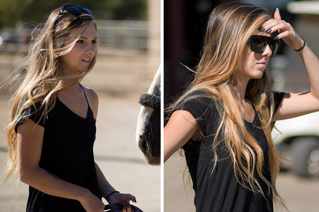 Young women working with a horse wearing Heat Wave Visual Regulator Sunglasses with black frame and black lenses.
