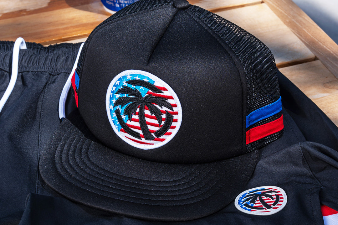 Lying on a pool chair is the Heat Wave Visual Icon RWB Foam Hat.