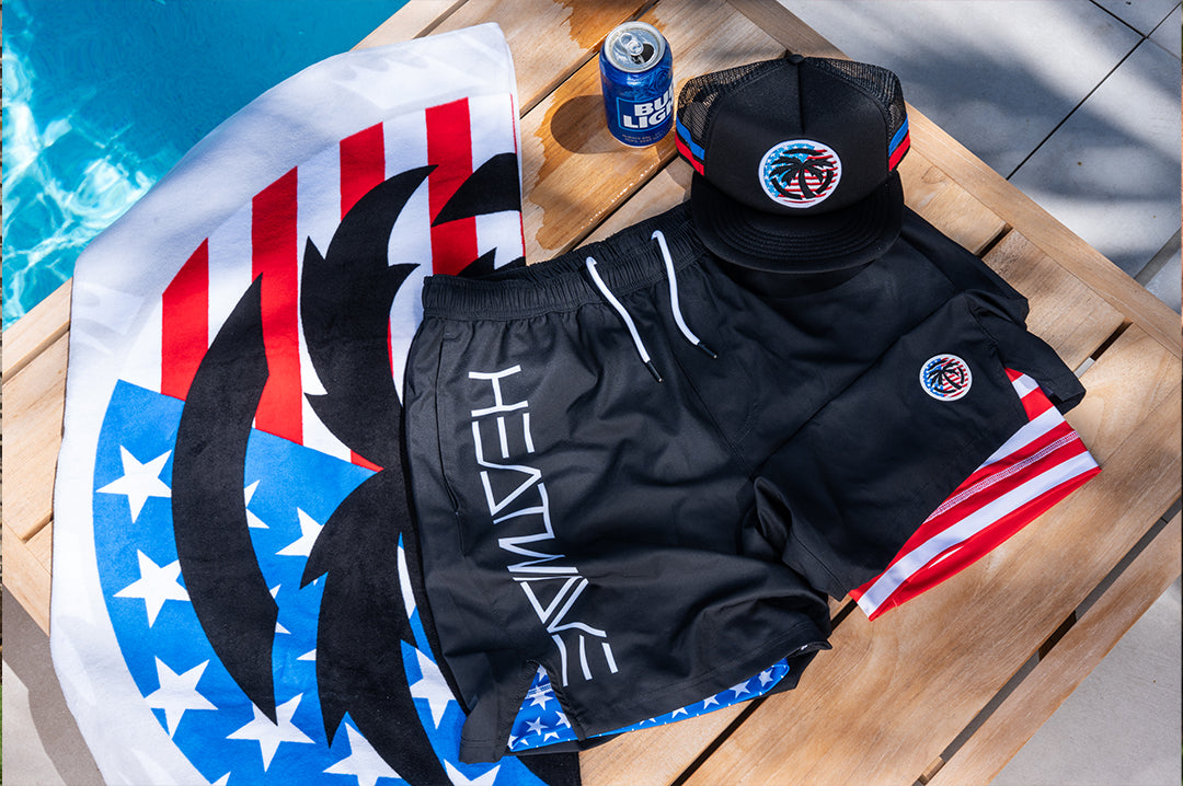 Lying on a pool chair is the Heat Wave Visual USA RWB Performance Shorts with flag inner liner. 