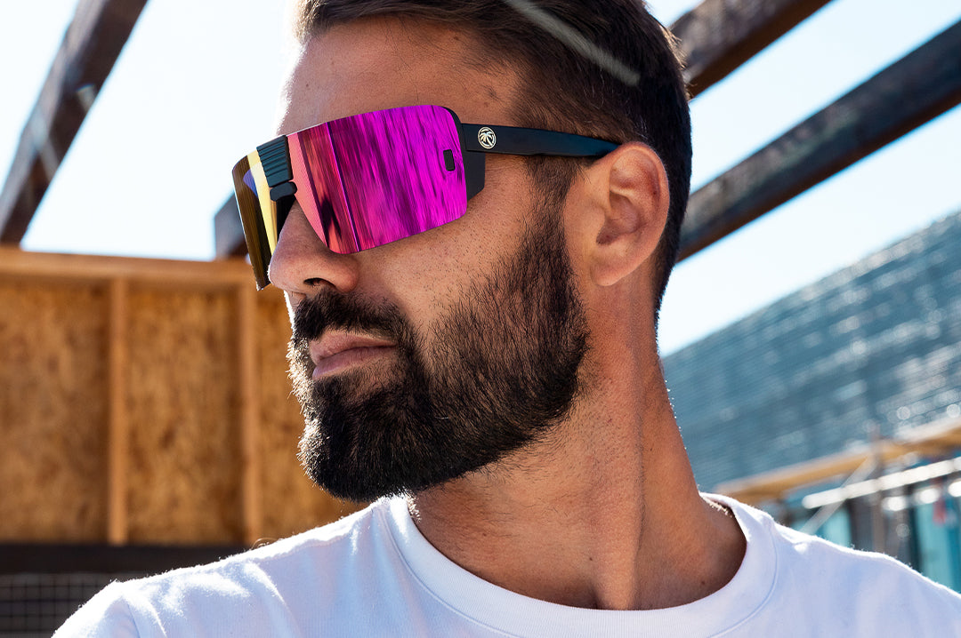 Young Dude wearing the Heat Wave Viusal Vector Sunglasses with black frame and spectrum pink yellow lens.
