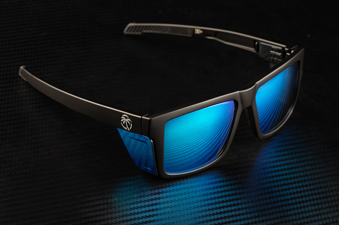 Angle view of the Heat Wave Visual Performance XL Vise Sunglasses with black frame, galaxy blue lenses and matching colored side shields.