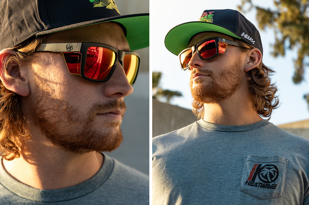Young dude wearing the Heat Wave Visual Performance Vise Sunglasses with black frame, firestorm red lenses and matching colored side shields.