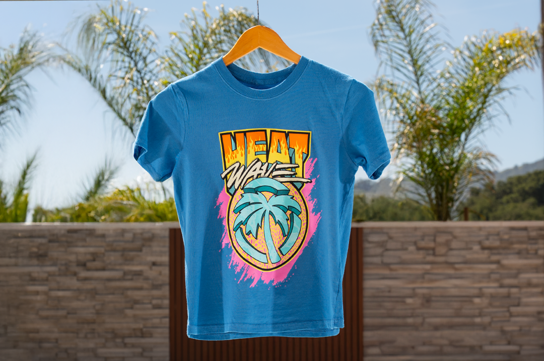 Heat Wave Visual Intense Youth Blue T-shirt hanging in from of a pool.